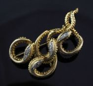 An 18ct gold and diamond brooch, modelled as four entwined serpents, each head set with three