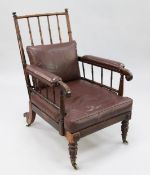A William IV rosewood armchair, with turned spindle back and part upholstered arms, brown leather