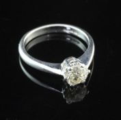 An 18ct white gold and solitaire diamond ring, the old cut diamond weighing 1.12ct, size P.