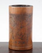 A Chinese bamboo brush pot, 19th century, incised with five figures of sages by a bamboo grove,