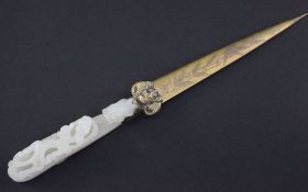 A Chinese white jade belt hook, 18th / 19th century, mounted in the early 20th century as a paper