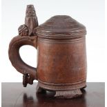 A 19th century Norwegian birch wood peg tankard, with carved thumb piece and domed lid, with