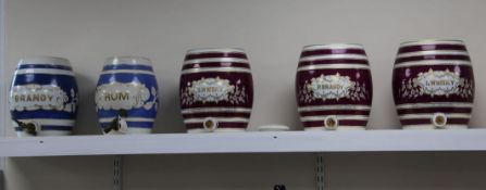 Five Victorian pottery spirit barrels, late 19th century, three of oval barrel form with gilt