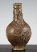 A German stoneware bellarmine jug, 16th / 17th century, the neck with typical impressed mask above