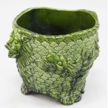 A large French green glazed pottery jardiniere, early 20th century, each side moulded in relief with