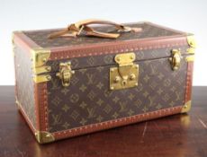 A Louis Vuitton rectangular vanity case, with key, with brass corners and leather handle, with