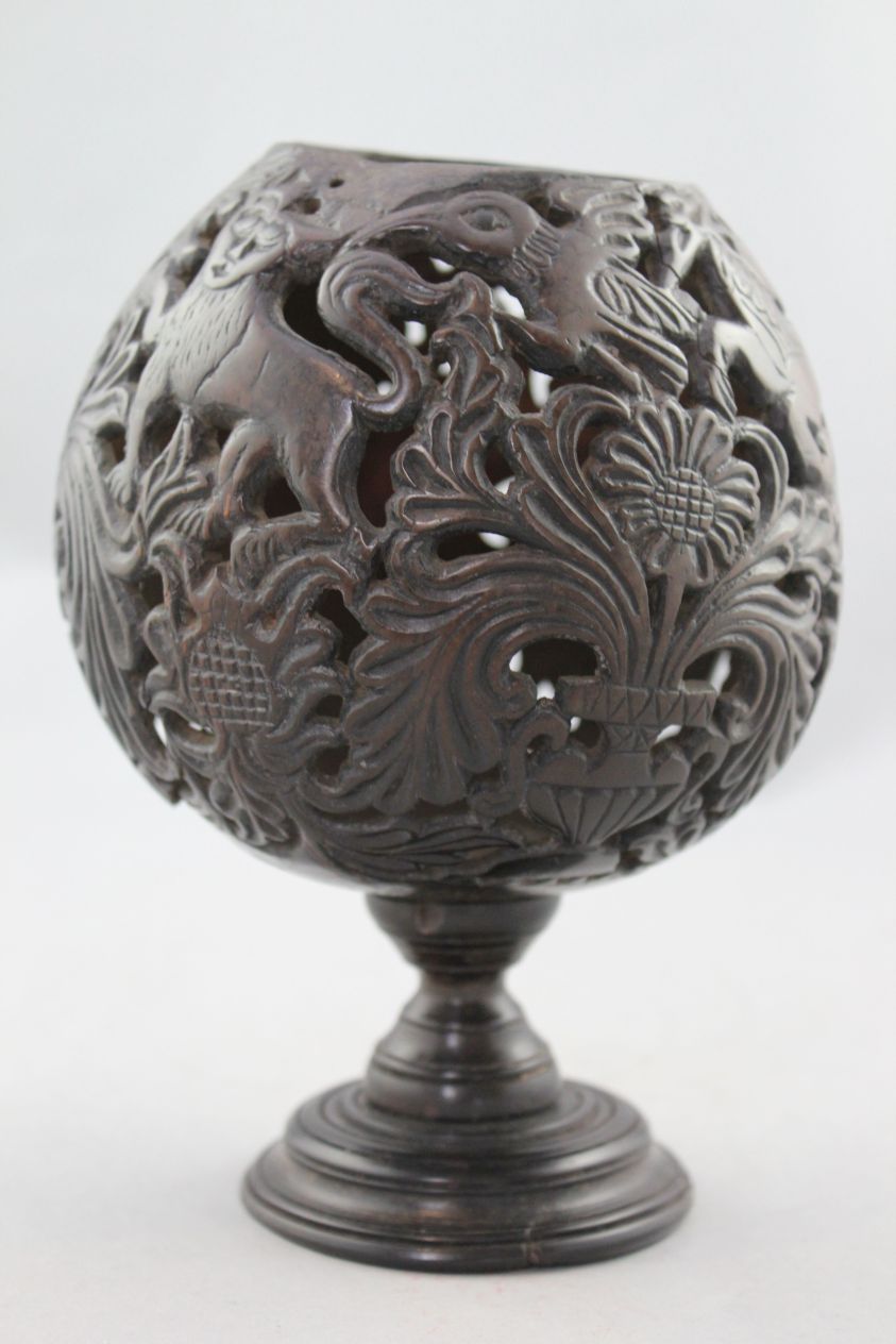 A 19th century carved and pierced coconut cup or goblet, decorated with owls, birds and vases of - Image 2 of 5