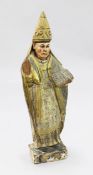 An 18th century Spanish carved and polychrome painted figure of a bishop standing with bible in left