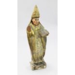 An 18th century Spanish carved and polychrome painted figure of a bishop standing with bible in left