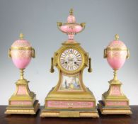 A 19th century French ormolu and Sevres style porcelain clock garniture, the architectural mantel