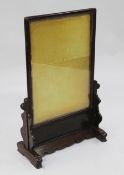 A Chinese rosewood table screen, early 20th century, with scroll carved uprights on trestle end