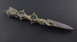 A bronze Tibetan ritual phurba dagger, with triple section tapering blade and mask finials, 11in.