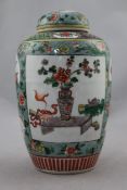 A Chinese famille verte ovoid jar and cover, late 19th century, painted with reserves of