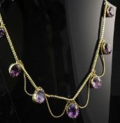 An early 19th century gold and foil backed amethyst fringe necklace, the snake link chain with