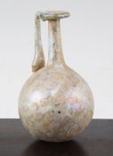 A Roman glass flask, c. 2nd century A.D., with mineral iridescence, globular body and looped handle,