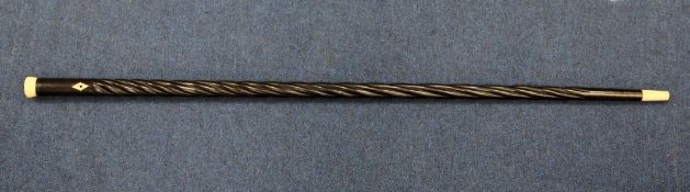 A late 19th / early 20th century ebony spiral twist turned walking cane, with circular bone