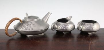 A Liberty Tudric pewter three piece tea set, no.0231, designed by Archibald Knox, comprising a squat