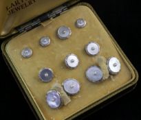 A 14ct gold, mother of pearl and seed pearl set nine piece dress stud set, in box.