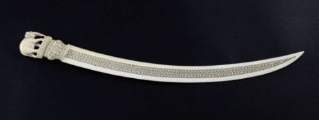 A late 19th century Indian ivory paper knife, with shaped pierced blade and floral carved handle