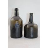 Two English dark green glass wine bottles, 18th century, the first of mallet form, 20cm., the second