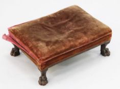 A George III rectangular mahogany foot stool, with over-stuffed top and reeded frame, on lion paw