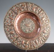 An Arts & Crafts Newlyn circular copper charger, by John Pearson, with basket, fruit, floral and