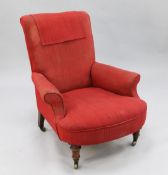 A Victorian Gillows deep seated armchair, with turned legs and castor feet, rear legs stamped