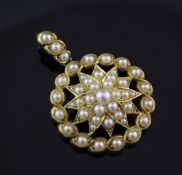 A Victorian style gold and split pearl set pendant, with pierced central starburst motif, overall