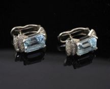 A pair of white gold, aquamarine and diamond earrings, set with emerald cut aquamarines and three