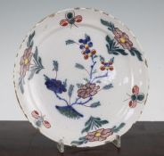 A Delft pottery dish, second quarter 18th century, painted with Chinese style polychrome flowers and