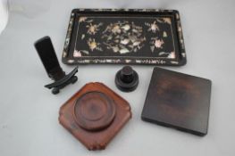 Four Chinese rosewood stands and a Chinese wood and mother of pearl inlaid tray, 19th / early 20th