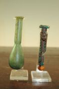 Two Roman glass unguentarium, c. 2nd century A.D., one with marbled body (damaged), the second