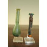 Two Roman glass unguentarium, c. 2nd century A.D., one with marbled body (damaged), the second