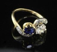 A 1940's/1950's? gold, sapphire and diamond crossover ring, with rose cut diamond set scrolling