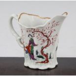 A Worcester Chelsea Ewer cream jug, c.1760, painted with Chinese figures in a fenced garden,