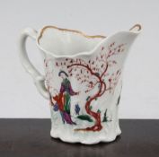 A Worcester Chelsea Ewer cream jug, c.1760, painted with Chinese figures in a fenced garden,