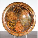 A Pilkington's Royal Lancastrian lustre dish, by Gladys Rogers, c.1914-20, painted with a flowerhead