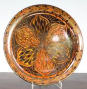 A Pilkington's Royal Lancastrian lustre dish, by Gladys Rogers, c.1914-20, painted with a flowerhead