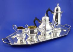 A matched George V 18th century design silver five piece tea set, of panelled form, comprising