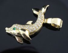 An 18ct gold and diamond set dolphin pendant by Cartier, with cabochon emerald eye, signed and