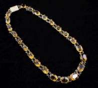 An early 20th century 9ct gold and citrine necklace, with engraved rectangular clasp and set with