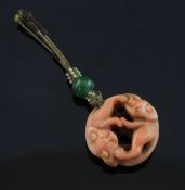 A 19th century Chinese coral pendant, carved with two mythical beasts, 1in.