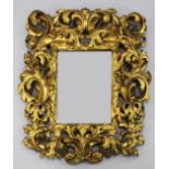 An 18th century Italian carved giltwood wall mirror, with pierced acanthus scroll frame and
