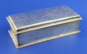 An Edwardian silver mounted cigarette box, of rectangular form, with gadrooned borders, Spink & Son,