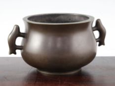 A large Chinese bronze baluster censer, Gui, applied with a pair of shaped loop handles,