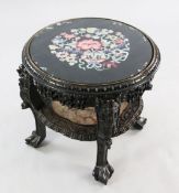 A Chinese carved rosewood circular two tier occasional table or urn stand, the top now with inset