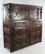 A 17th century and later carved oak court cupboard, with reeded cup and cover uprights and an