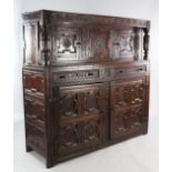 A 17th century and later carved oak court cupboard, with reeded cup and cover uprights and an