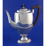 An Edwardian demi-fluted silver pedestal coffee pot, by Walker & Hall, of oval form, with ebonised