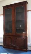 A large early 19th century mahogany library bookcase, fitted two glazed doors enclosing three